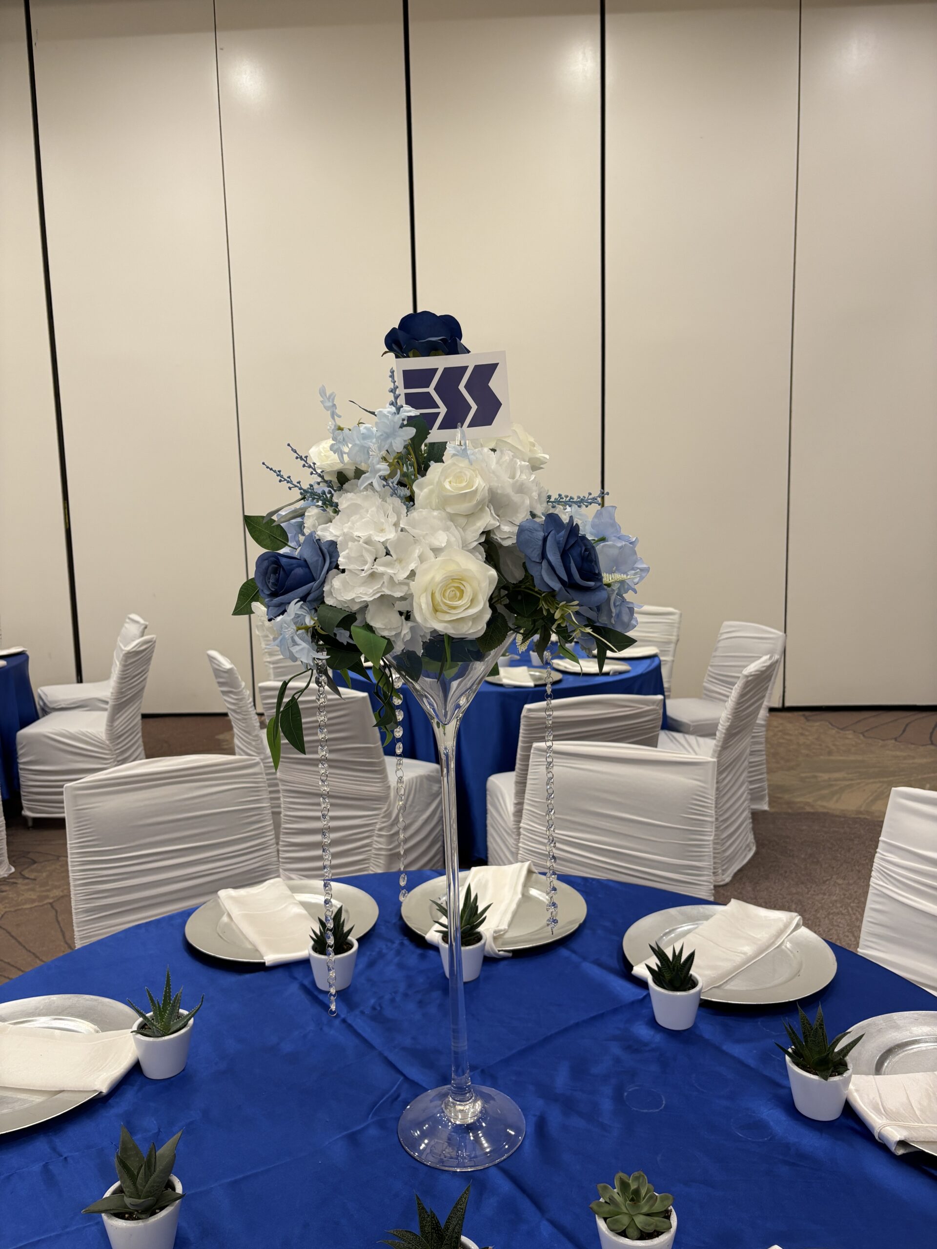 Blue and white corporate event table and seating setup