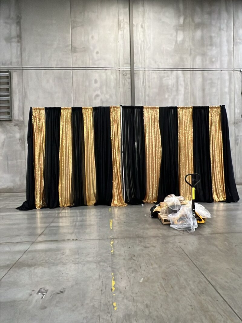 Black and sequin backdrop for a corporate event in a transformed warehouse